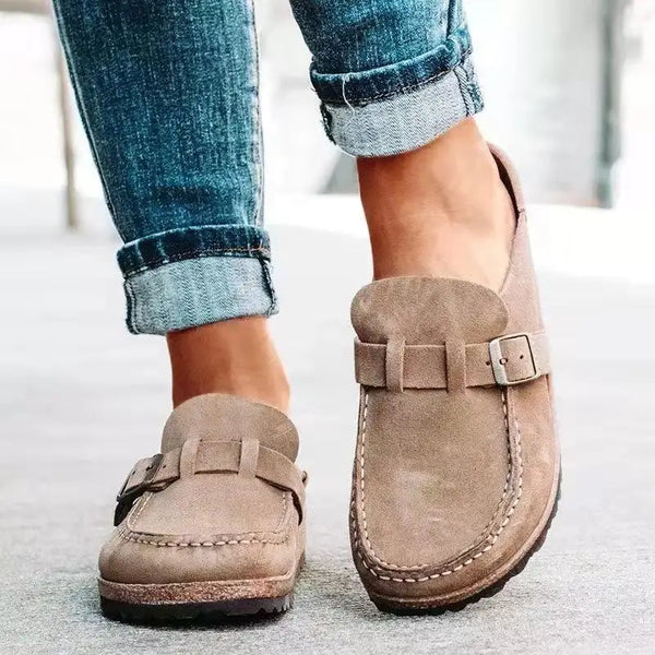 Casual mules with decorative buckle accent and slip-on convenience for easy on-off functionality
