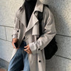 Men's long double-breasted trench coat in solid color with turn-down collar, perfect for autumn and winter streetwear.