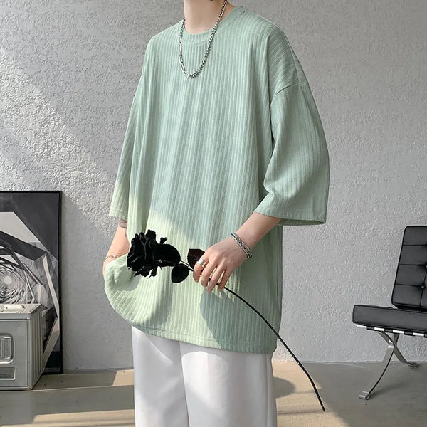 Detail of short sleeves on striped summer tee, designed for warm weather wear.