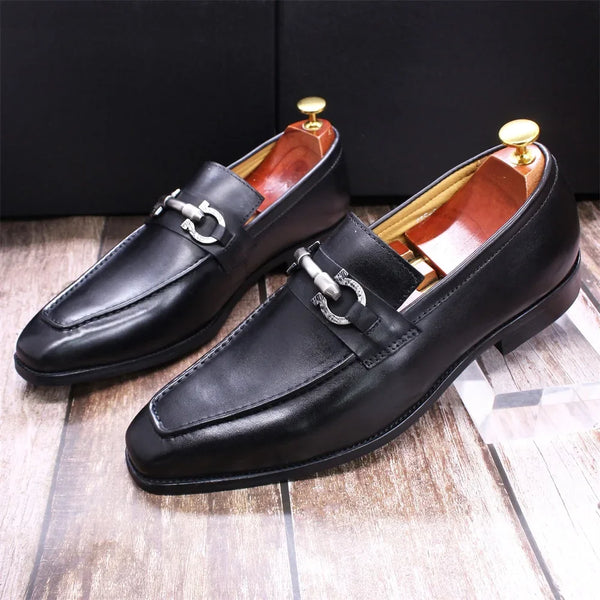 Close-up of premium cow leather texture on black formal loafers