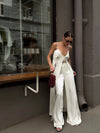 Detail of high-waist design on white satin bottoms with comfortable loose fit