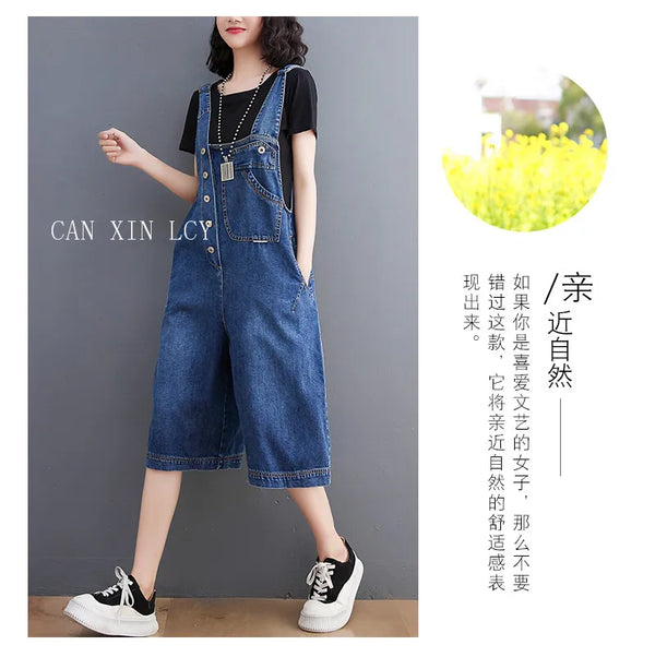 Woman in loose fit denim suspender jumpsuit walking showing movement and flow of wide leg pants