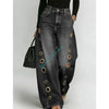 Wide leg black jeans featuring metal grommet accents and button fly closure with relaxed fit