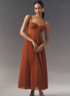 Pleated cocktail dress with flattering mid-calf length and unique suspender design
