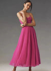 Elegant evening dress showcasing high-waist pleating and architectural suspender details
