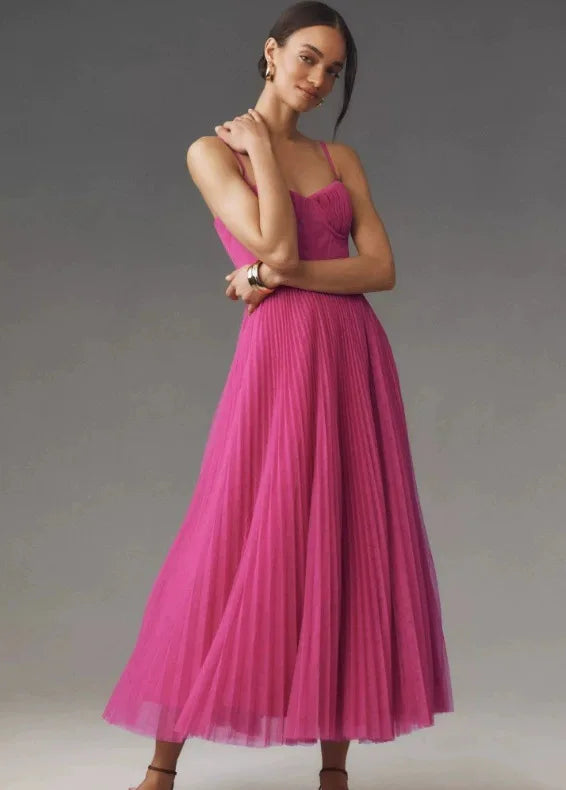 Elegant evening dress showcasing high-waist pleating and architectural suspender details