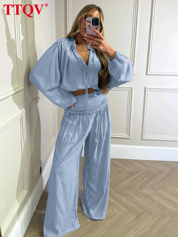 Elegant loose fit blouse and high-waist wide pants in versatile neutral tone