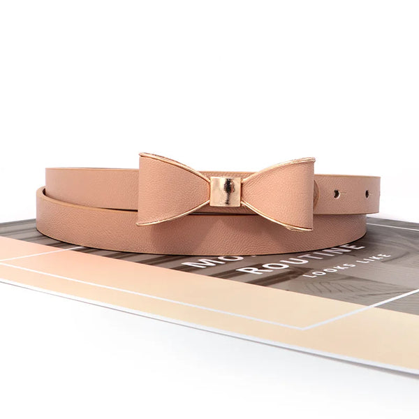 Elegant women's belt with bow detail in faux leather, perfect for casual and formal outfits, featuring a sleek metal buckle.
