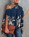Elegant floral print blouse with batwing sleeves, halter collar, and soft cotton-polyester blend for all-season style.