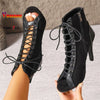 Black dance boots featuring cross-lacing, hollow cutouts, and quick-change zip closure