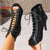 Black dance boots featuring cross-lacing, hollow cutouts, and quick-change zip closure