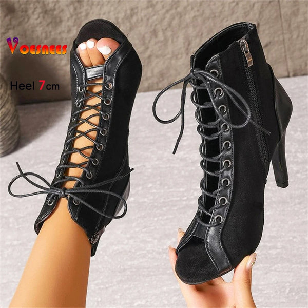 Black dance boots featuring cross-lacing, hollow cutouts, and quick-change zip closure