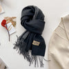 Stylish imitation cashmere scarf in soft cream, ideal for winter outings.