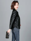 Chic women's sheepskin leather jacket with zippered front, turn-down collar, and pockets for stylish autumn layering.