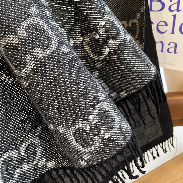 Lightweight cashmere shawl draped elegantly over shoulders, perfect for winter outings.