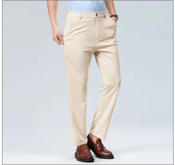 Detail of slim-fit dress pants waistband with belt loops and zipper fly construction