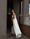 White satin coordinates laid flat showing button-front top and high-waist pants