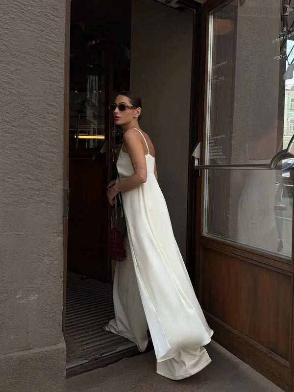 White satin coordinates laid flat showing button-front top and high-waist pants