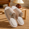 Person curled up reading with feet in cozy linen slippers