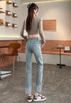 Chic high waist straight leg jeans for women in distressed wash, perfect for casual outings and office wear.