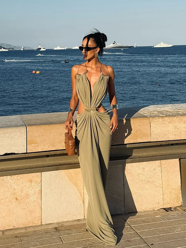 Woman wearing halter neck backless dress with strategic waist cutouts for summer events