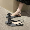 Chic flat sandals featuring pointed design, soft lining, and butterfly-knot charm