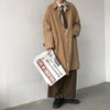 Chic Japanese vintage trench coat for men in black, perfect for autumn and winter travel with a stylish turn-down collar.