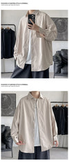 Oversized long sleeve casual shirt for men and women in solid color, featuring a Mandarin collar and single-breasted closure.