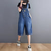 Woman wearing relaxed fit denim jumpsuit with suspenders and functional pockets for casual streetwear style