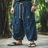 Navy streetwear pants featuring elastic waistband and distinctive vintage lacing