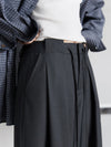 Full-length pleated trousers featuring flowing wide leg design and comfortable drawstring waist