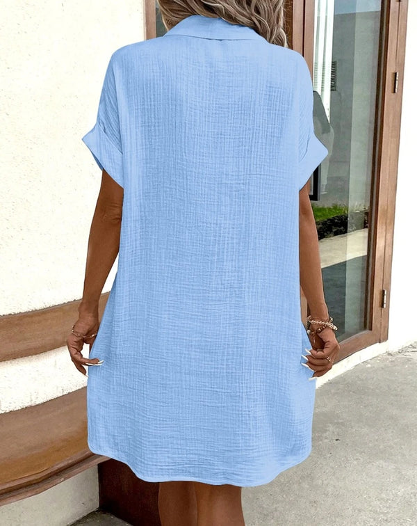 Detail shot of dress V-neckline showing elegant cut and soft fabric drape
