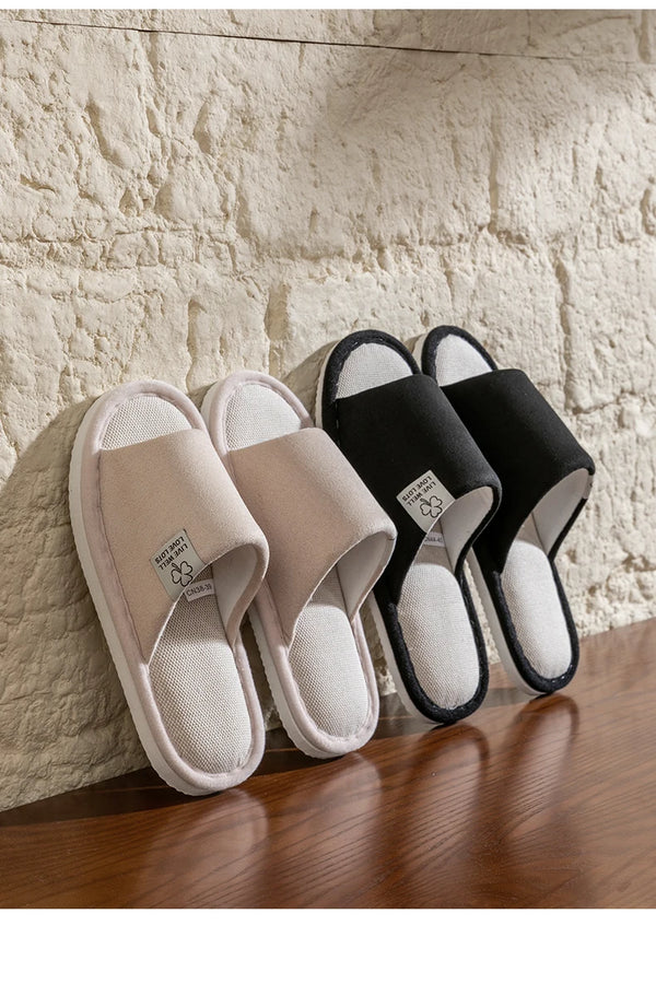 Linen slippers on wooden surface showing breathable material and solid pattern