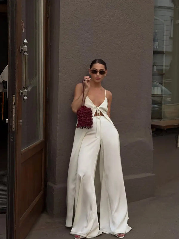 Model wearing white satin button-front top with high-waist coordinating bottoms
