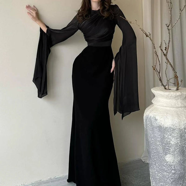 Full-length view of tailored batwing sleeve dress with flattering sculptured folds