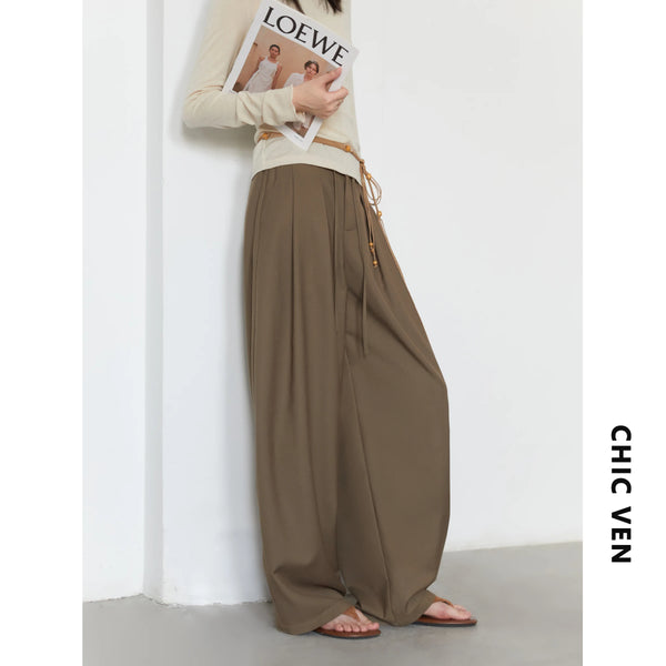 Comfortable high-waisted pleated trousers featuring graceful wide leg design and adjustable closure