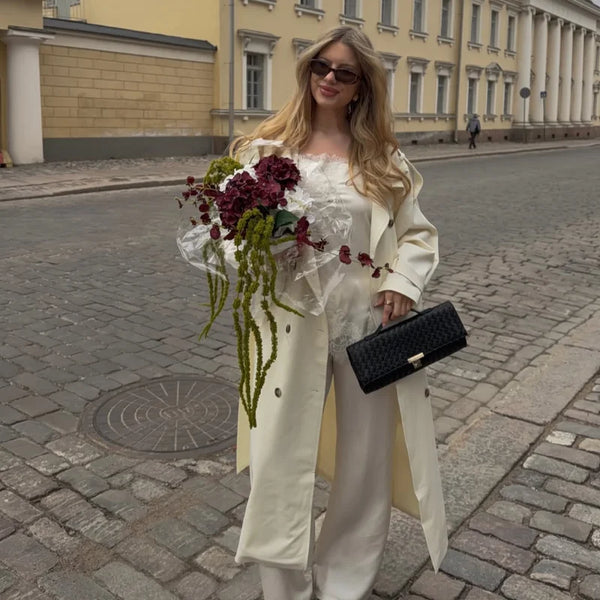 Classic polyester trench coat in cream showing double-breasted button configuration