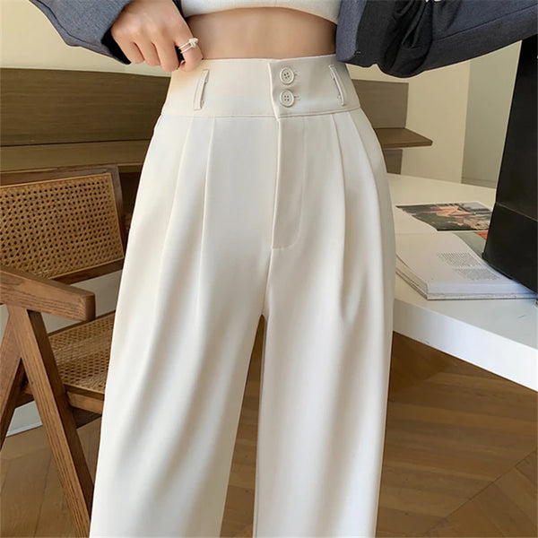 Black high-waist wide leg trousers with decorative button detail and flowing silhouette on white background