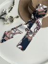Chic fabric belt for women with geometric design, versatile for dresses, jeans, or as a scarf and headband accessory.