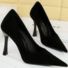 Classic black slip-on stilettos featuring thin high heels.