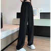 Full-length wide leg trousers in black showing flattering high-rise waist and flowing fit