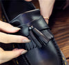 Black tassel loafers with a luxurious feel and polished appearance.