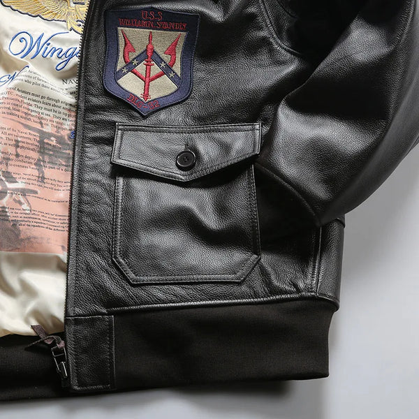 Close-up of the intricate embroidery on the chest of the leather bomber jacket.