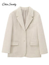 Woman wearing creamy white mohair blazer with turn-down collar styled over casual outfit for autumn