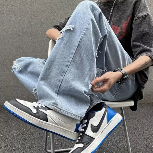 Men's black denim jeans with a modern hip hop influence and relaxed fit.