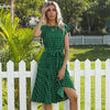 Polka dot midi dress hanging showing full length and pleats