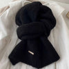 Cozy scarf folded neatly, showcasing its lightweight design and plush material.