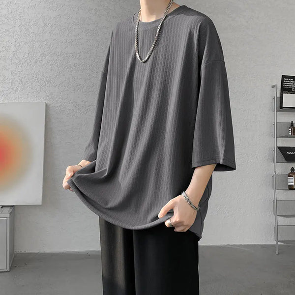 Flat lay of striped summer tee with beach essentials, perfect for summer fun.