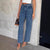 Beaded Cross-Waist Frayed Hem Jeans in Blue denim - Straight-Leg style - Sizes XS to L - Chic and comfortable urban fashion.